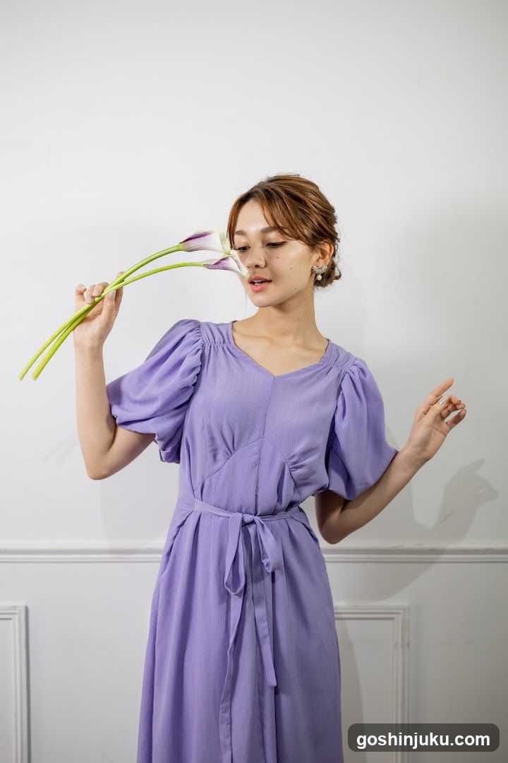 Woman in purple dress holding flowers