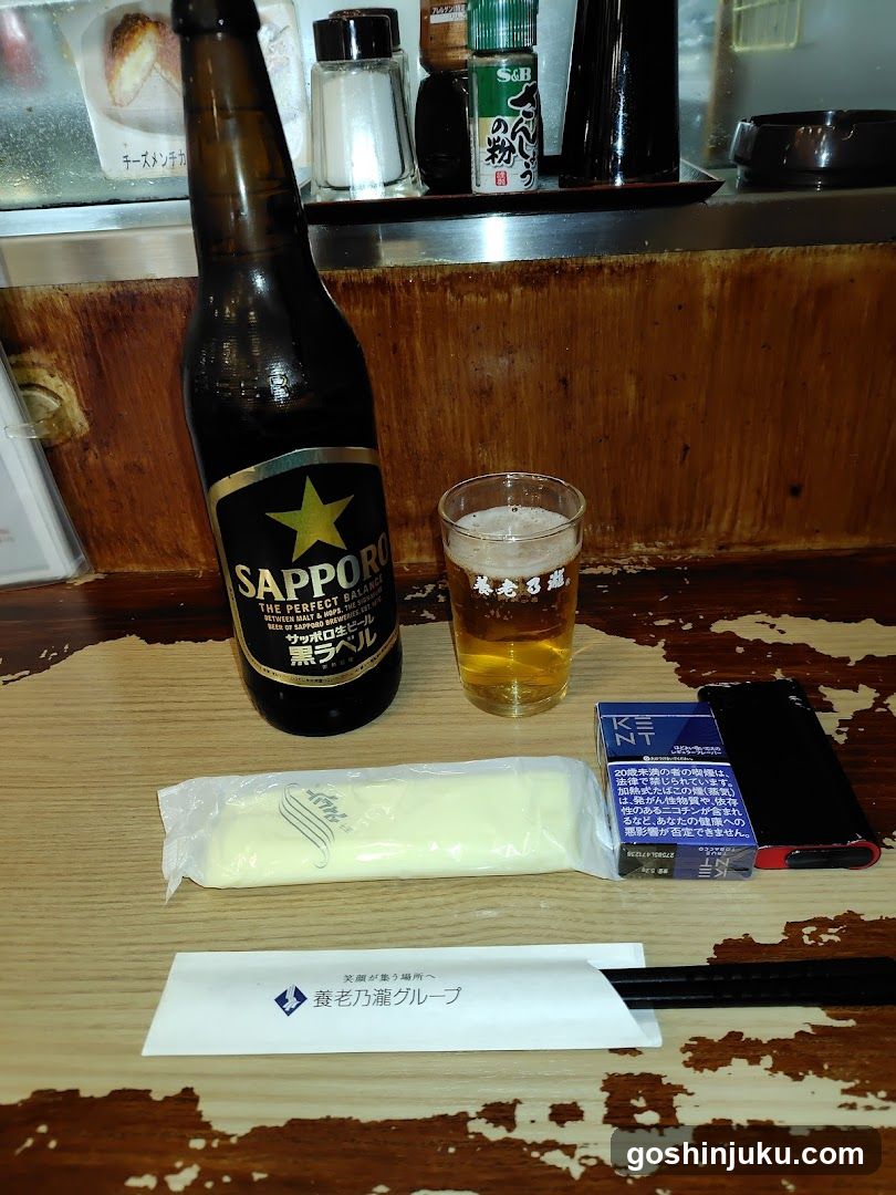 Sapporo Beer and Side Items on Wooden Table