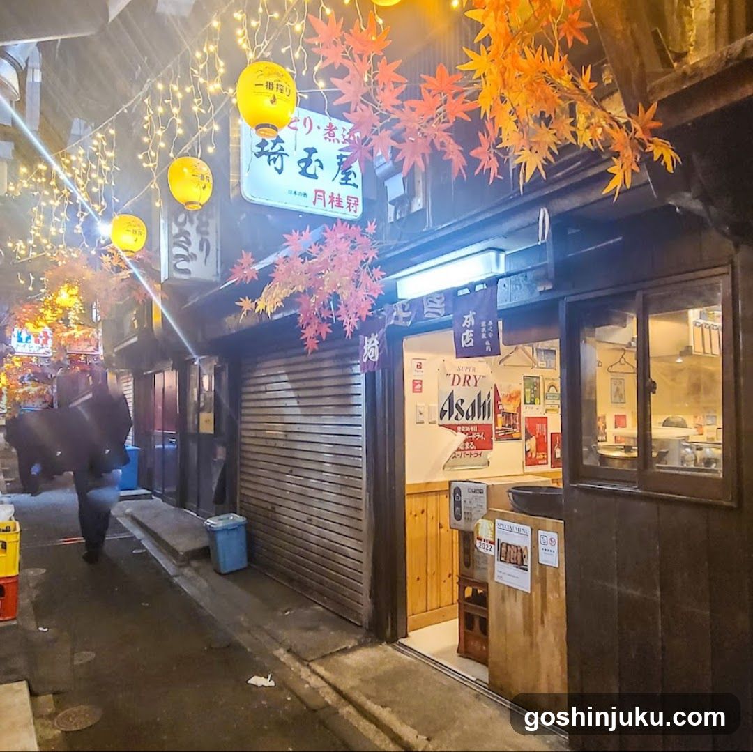 Night street scene with illuminated shop entrance and autumn decorations