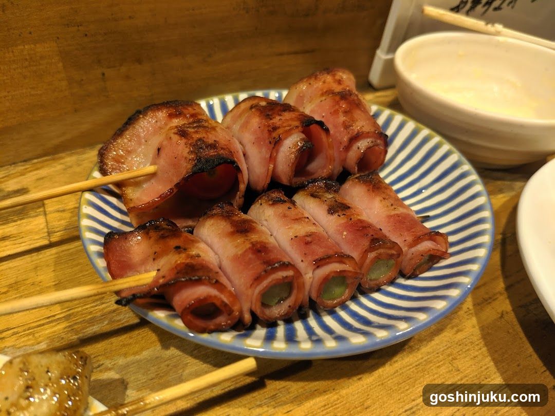 Bacon-wrapped skewers on a striped plate