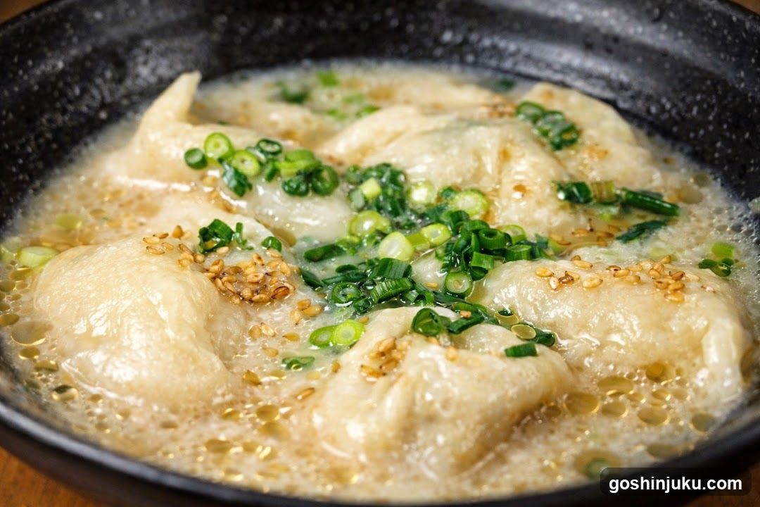 Dumplings in Broth with Scallions and Sesame Seeds