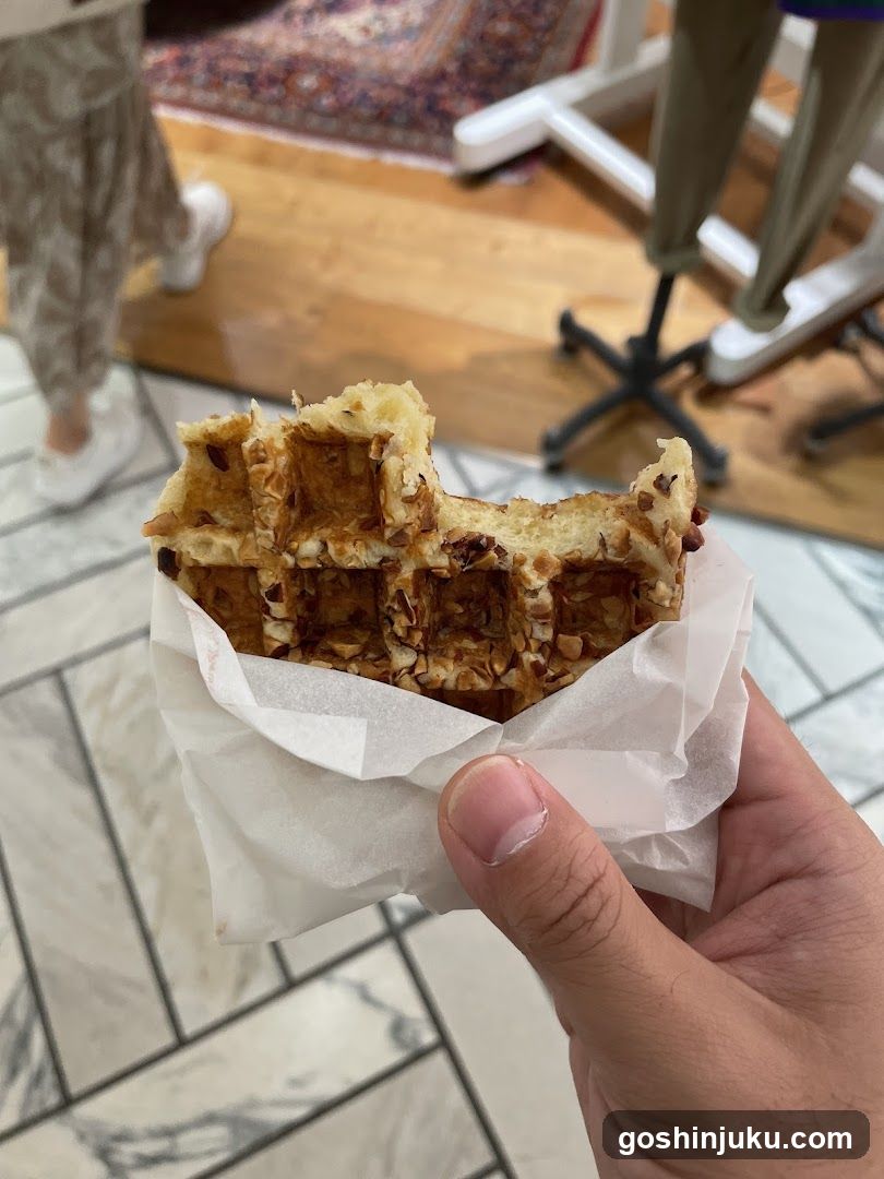Hand holding a waffle sandwich