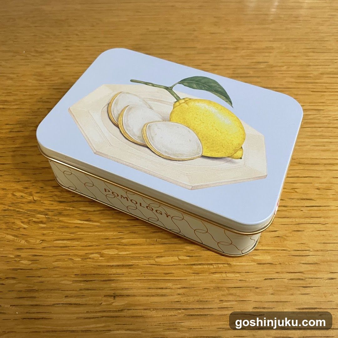 Lemon-themed tin box on wooden surface