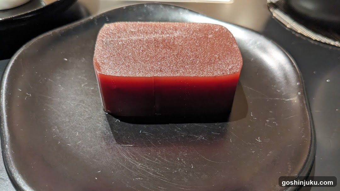 Red Jello Dessert on Black Plate