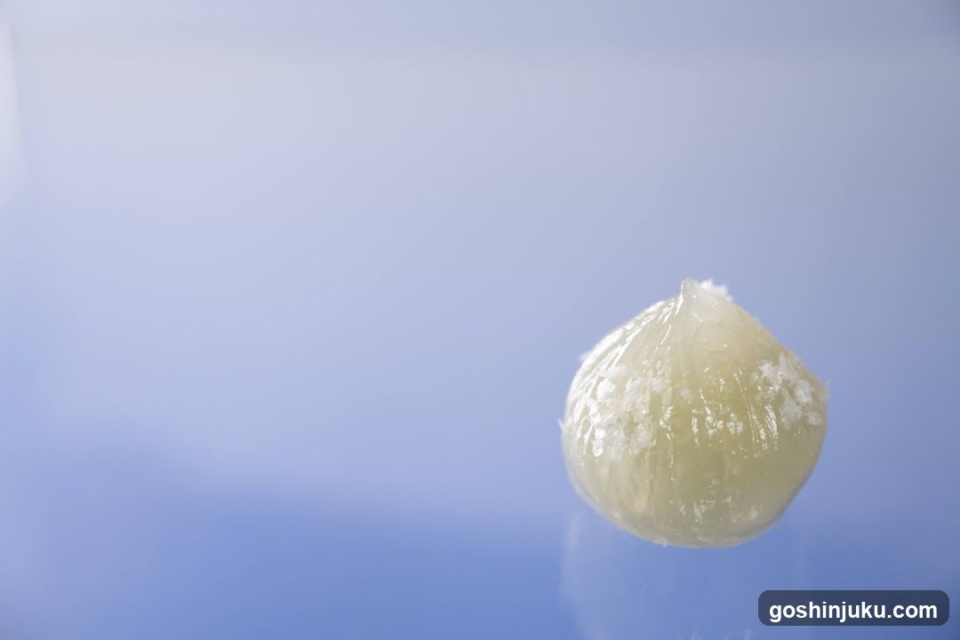 Single Garlic Clove on Blue Background