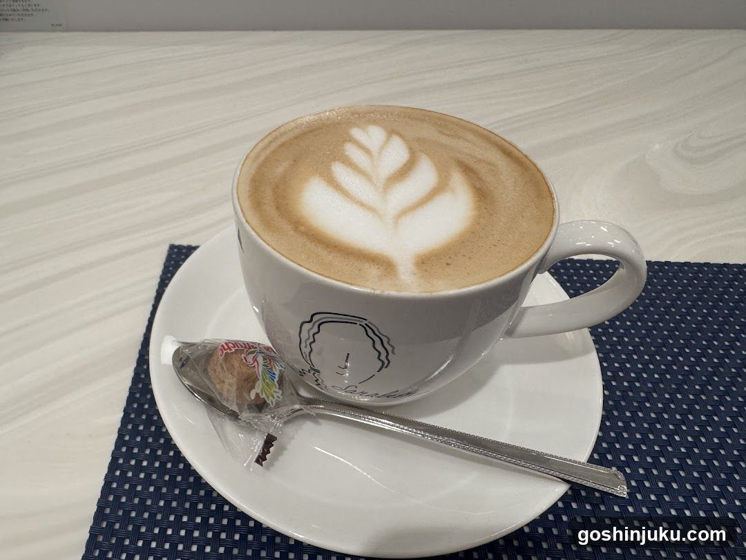 Latte with Leaf Art and Wrapped Cookie