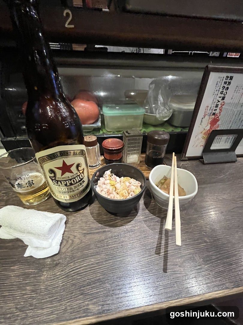 Sapporo Beer and Side Dishes at a Bar Counter