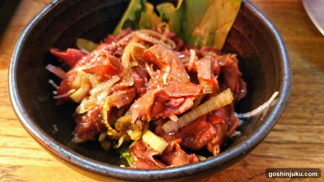 Bowl of Marinated Meat with Onions and Greens