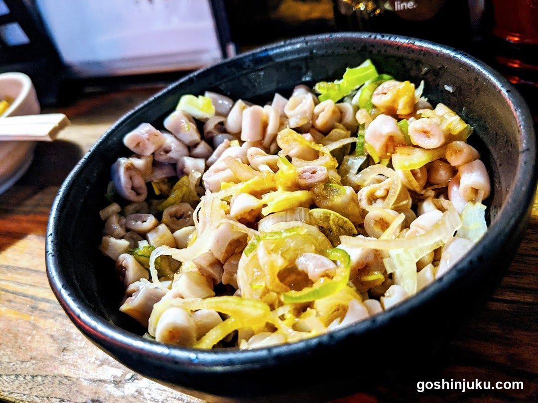 Bowl of stir-fried squid with leeks and peppers
