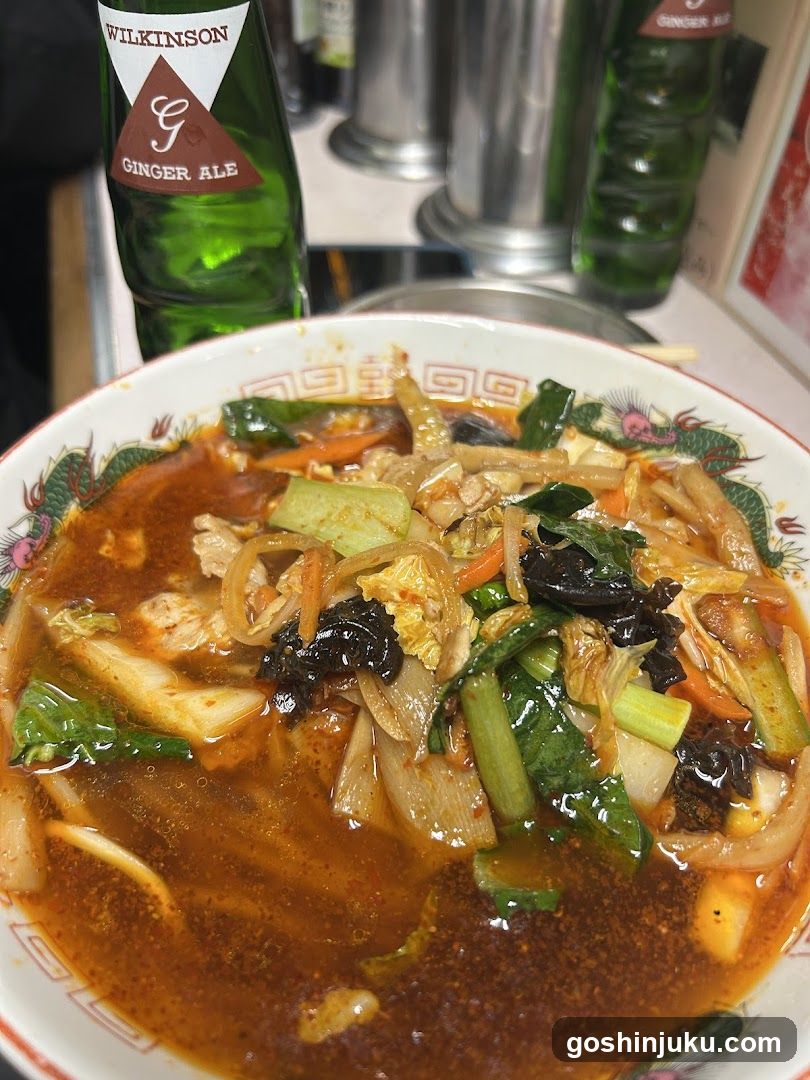 Bowl of spicy noodle soup with ginger ale