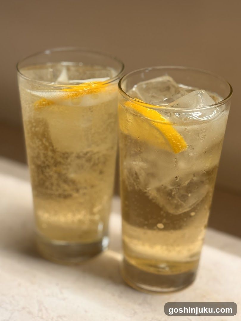 Two glasses of lemonade with ice and lemon slices
