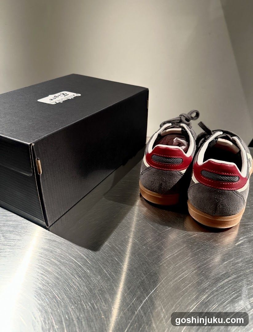 Sneakers and Shoebox on Metal Surface