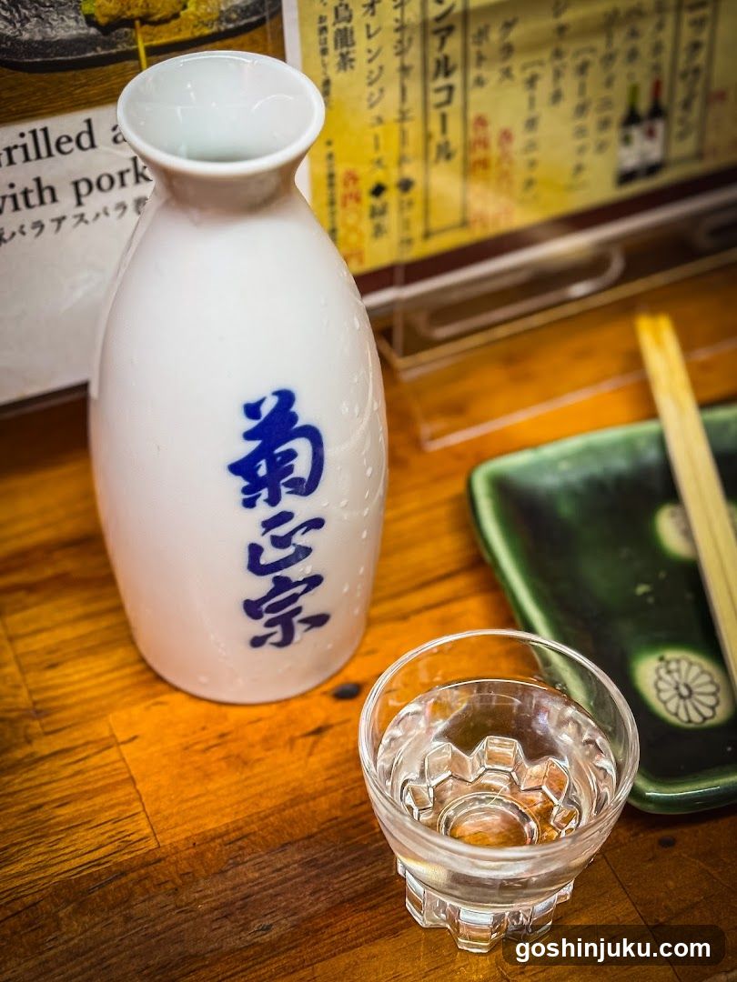 Sake bottle and cup on wooden table