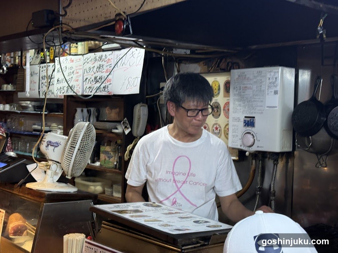 Chef in Kitchen with Breast Cancer Awareness Shirt