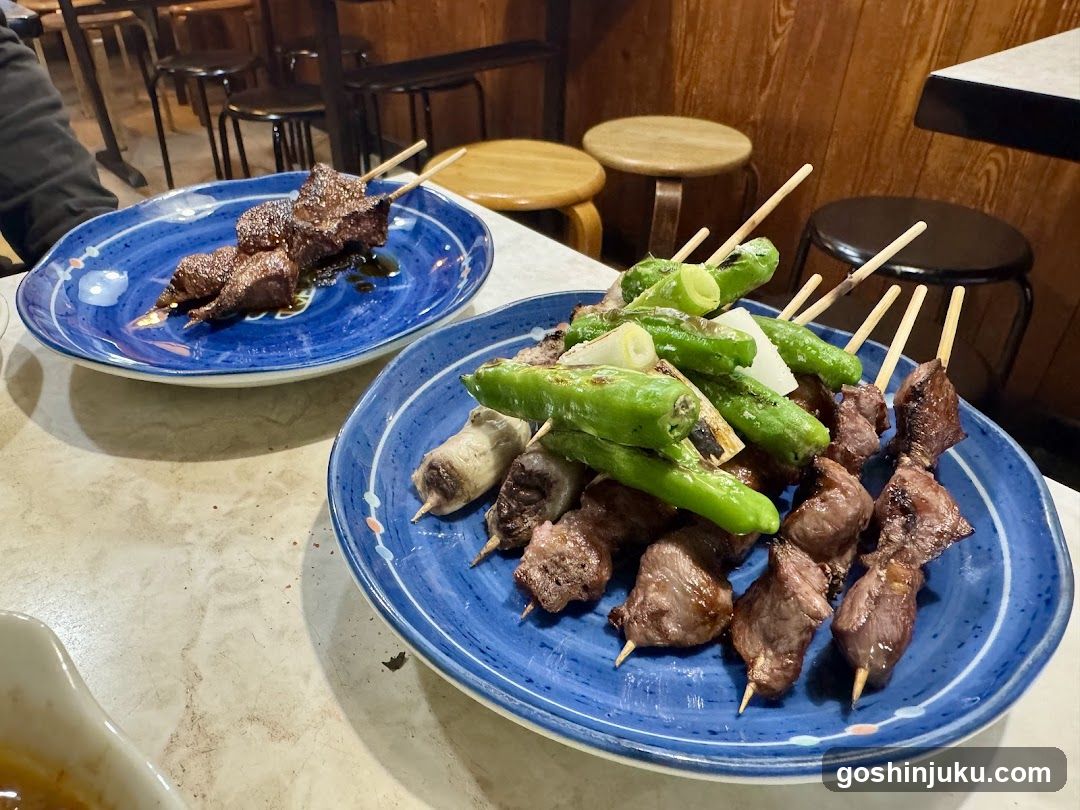 Yakitori and Shishito Peppers on Blue Plates