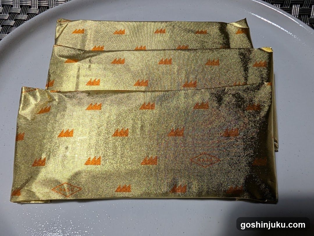 Gold-wrapped items on a plate