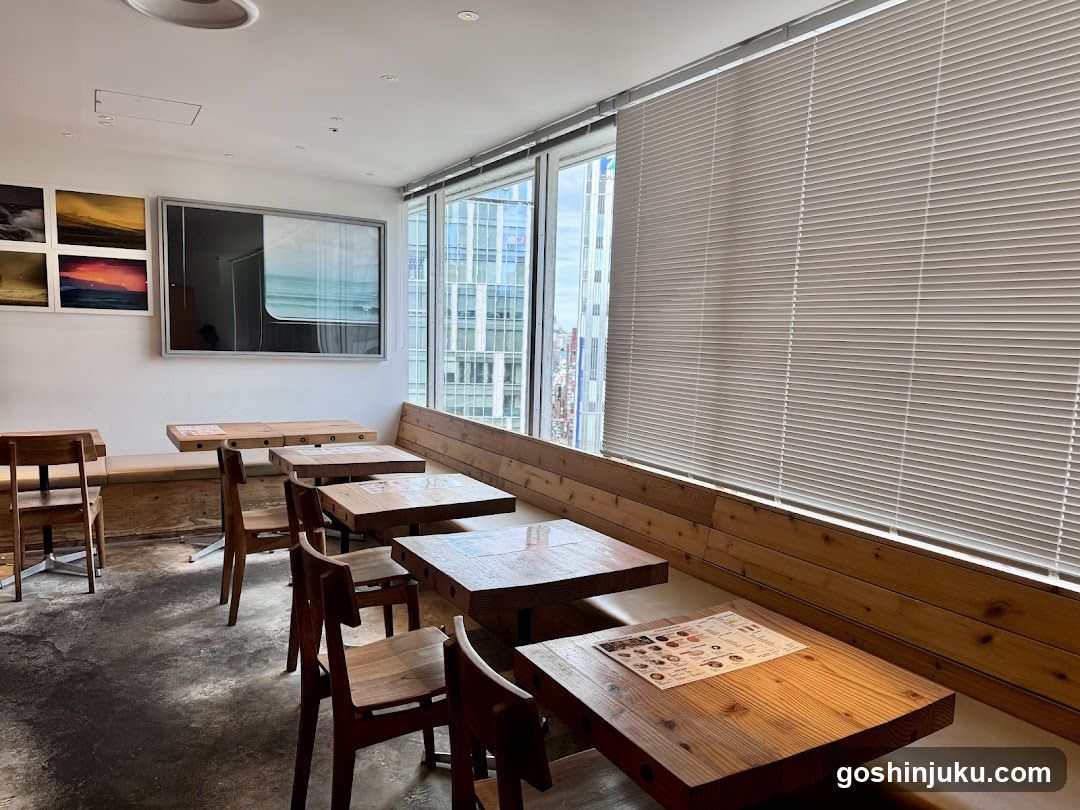 Interior of a modern café or restaurant with wooden tables and large windows