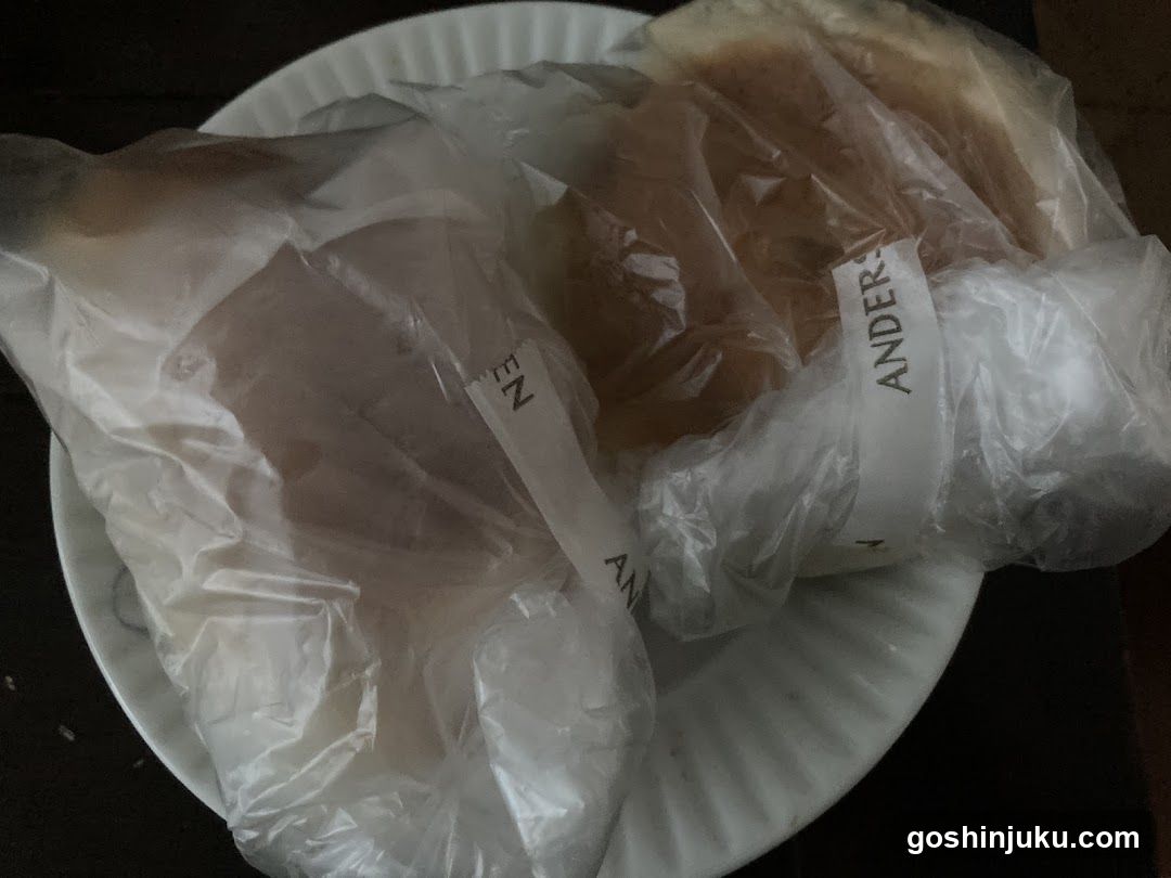 Plastic-wrapped food items on a plate
