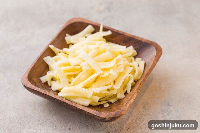 Shredded Cheese in Wooden Bowl