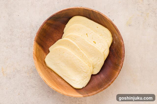 Sliced Cheese in Wooden Bowl