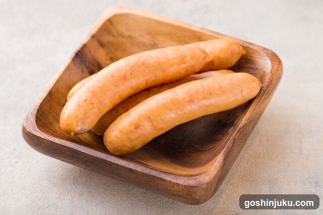 Sausages in wooden bowl