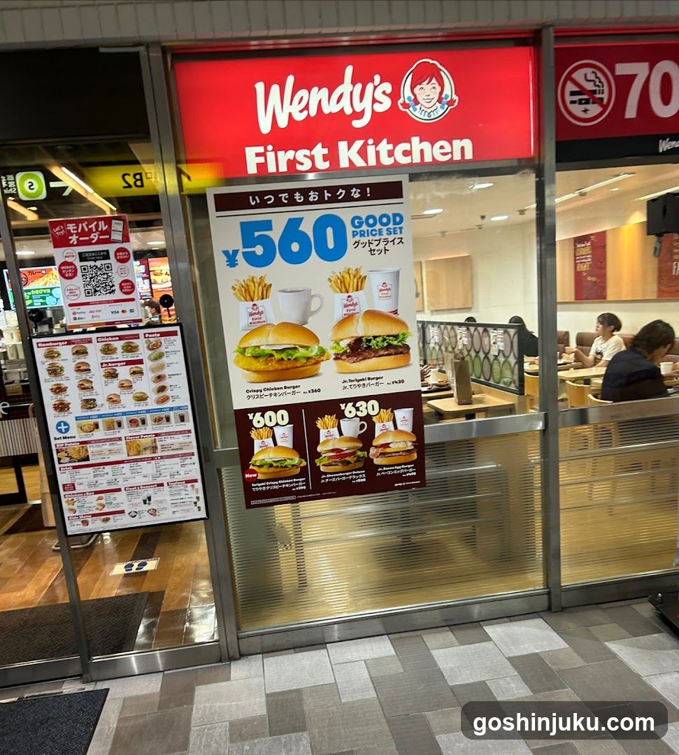 Photo of Wendy's First Kitchen storefront with visible signage and promotional posters inside the glass entrance.