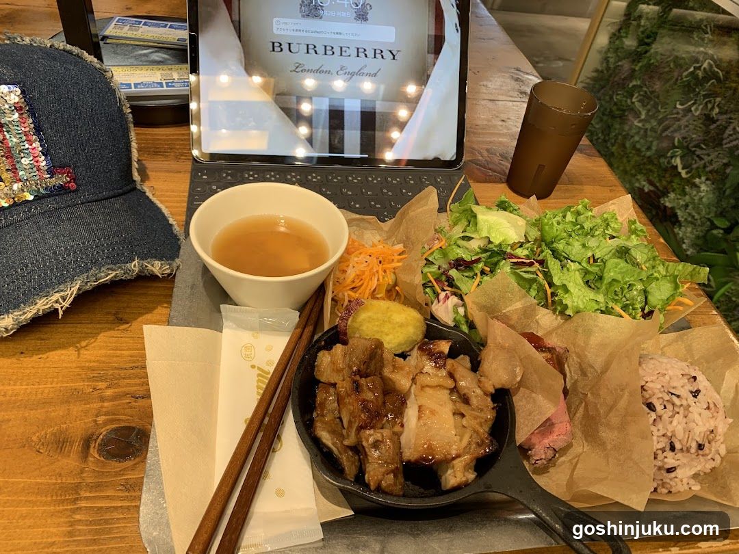 Burberry-themed meal setup with food and tablet display