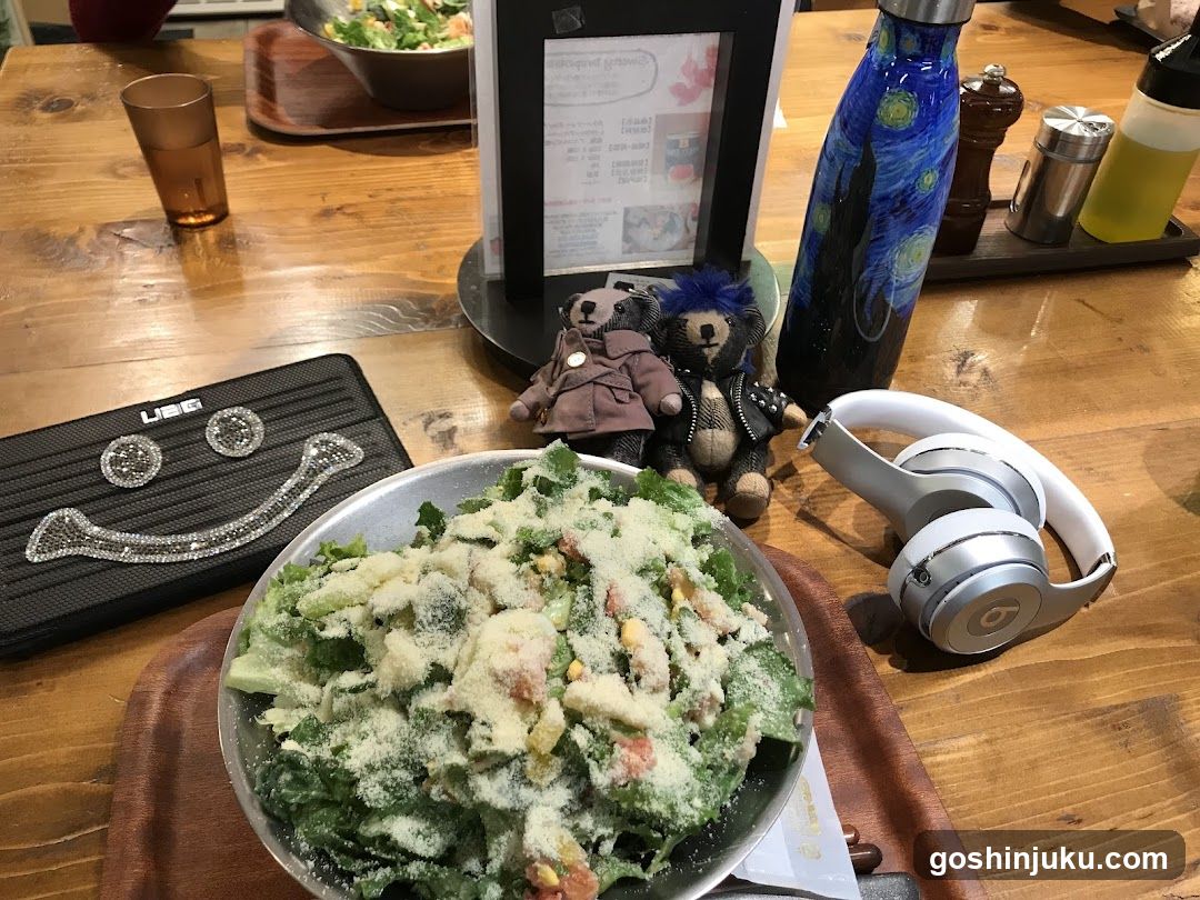 Salad with headphones and stuffed animals on table