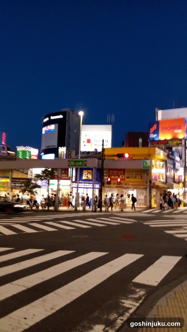 Night street scene with illuminated buildings and crosswalk