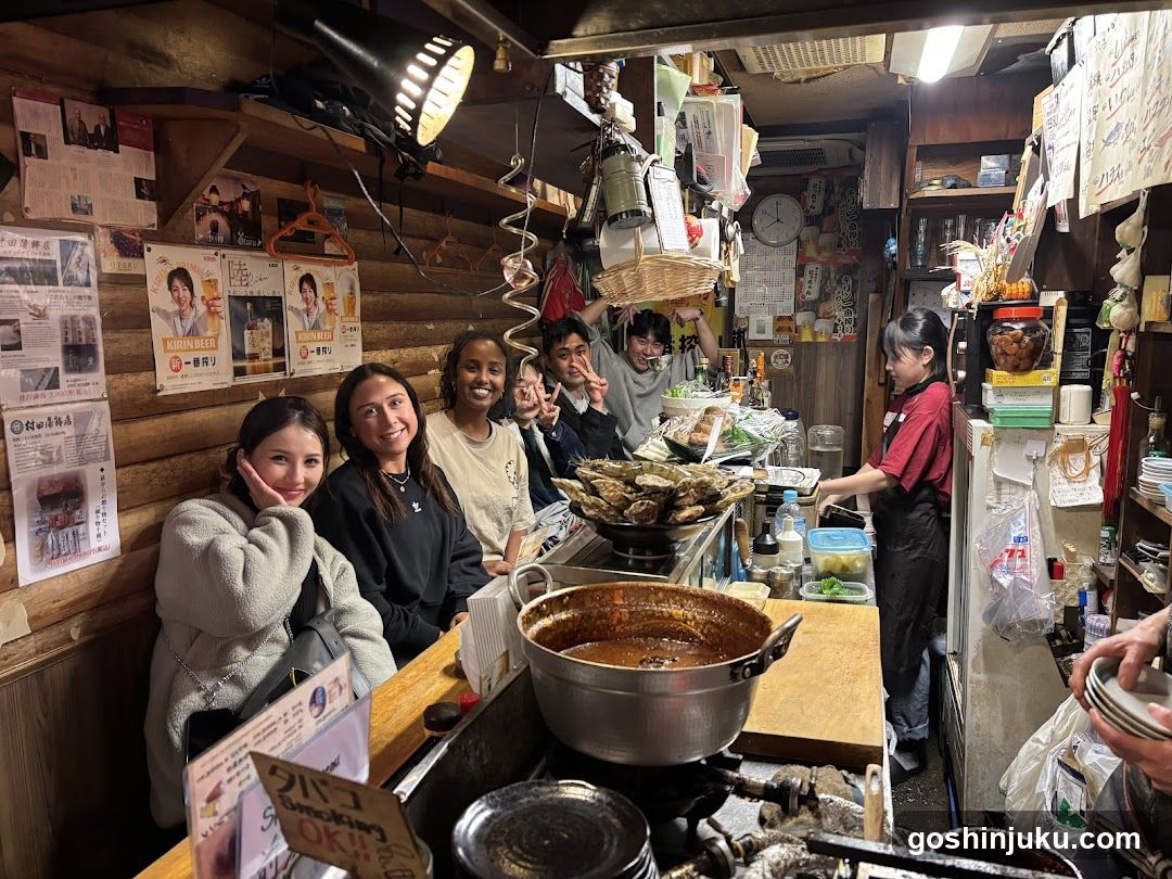 Group of people in a cozy Japanese izakaya-style shop interior