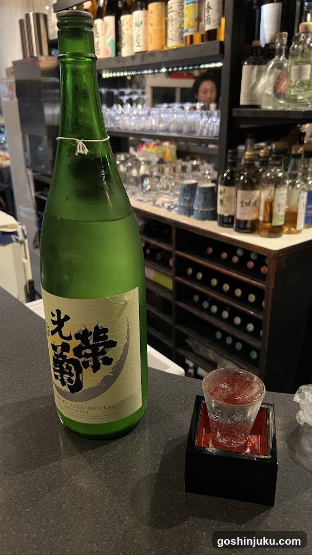 Sake Bottle and Shot in Bar Interior