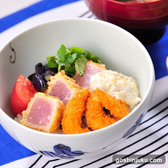Bowl of Japanese-style rice dish with tuna, shrimp, and vegetables
