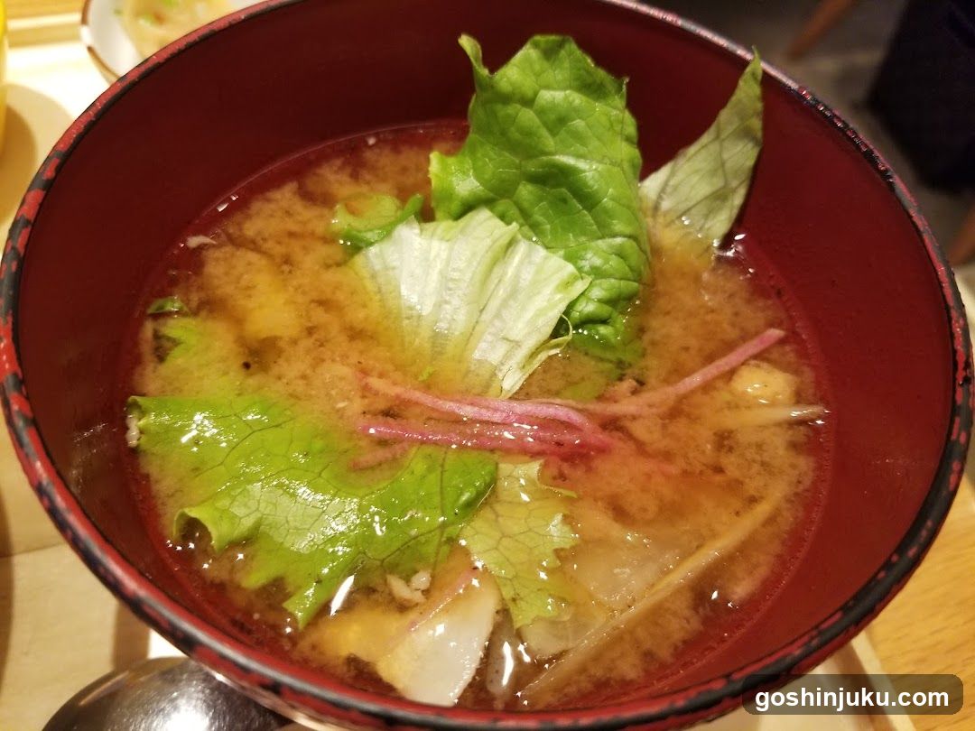 Bowl of Soup with Greens and Pickles