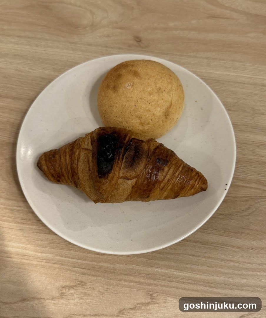Croissant and Bun on Plate