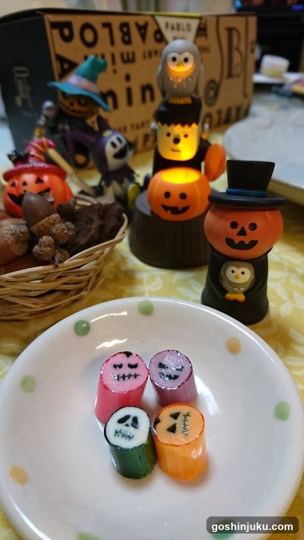Halloween-themed table display with candy and decorations
