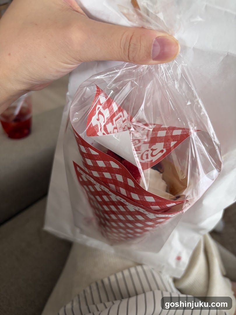 Hand holding food in branded bag