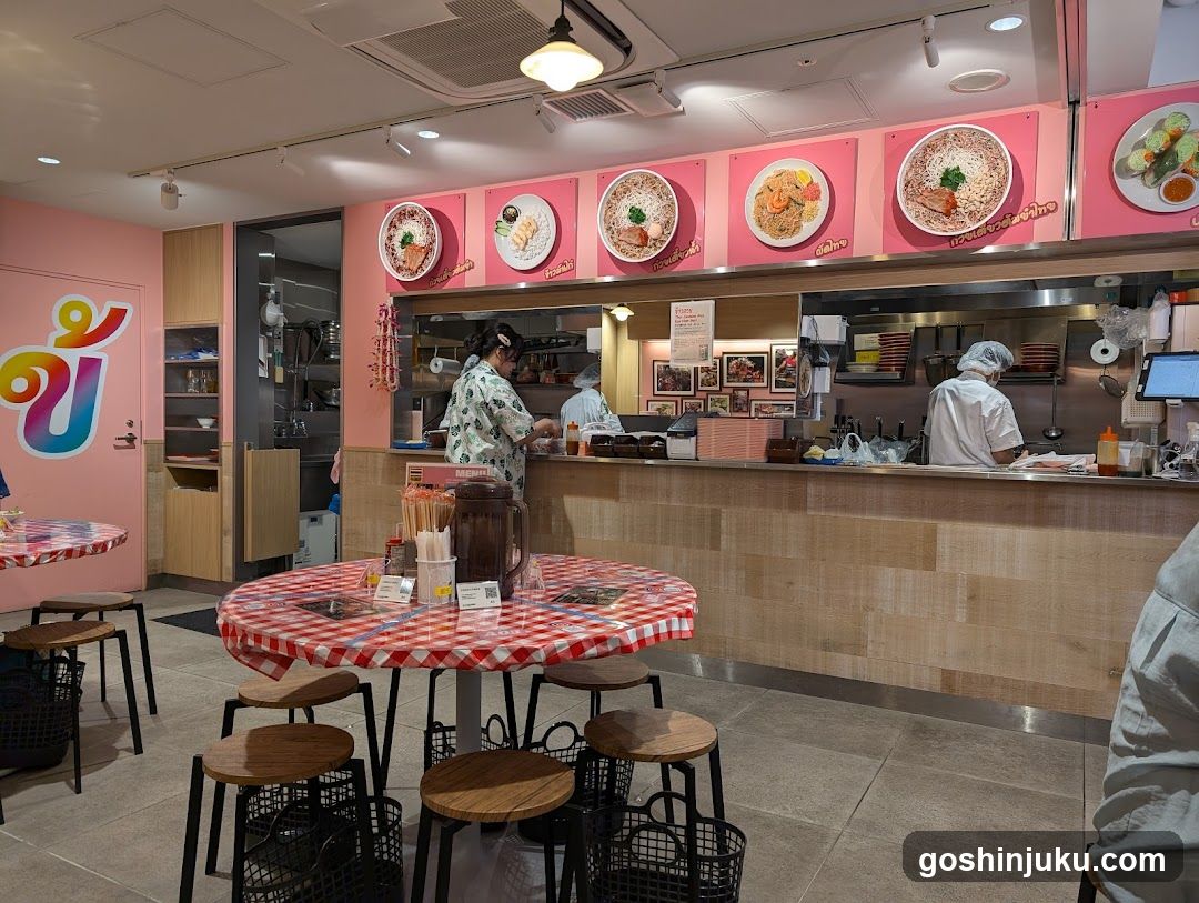 Restaurant Interior with Pink Walls and Kitchen View