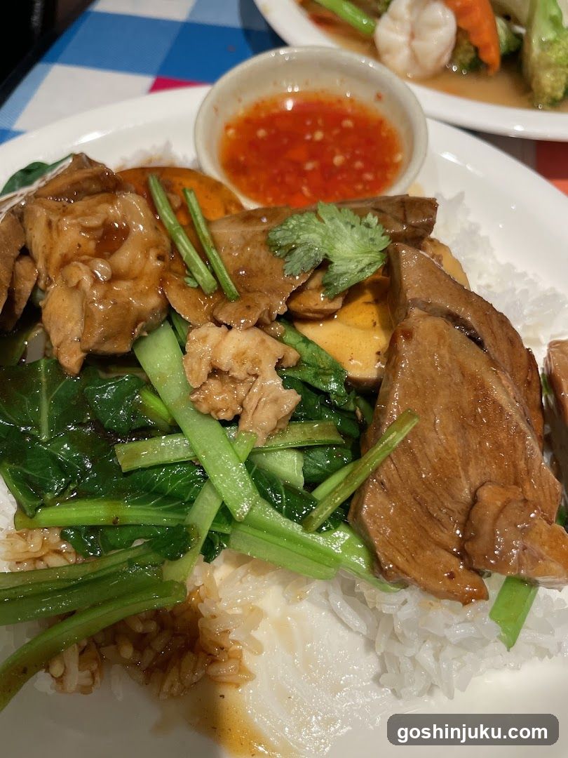 Thai-style rice bowl with meat and greens