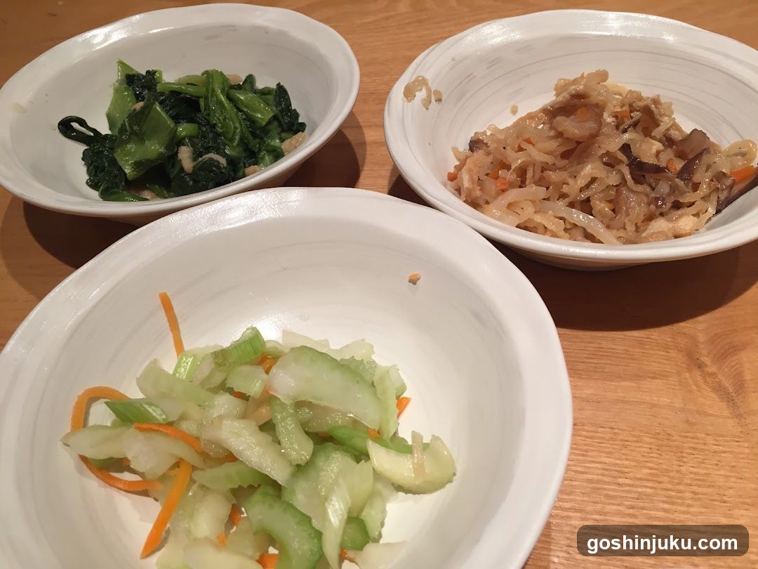 Three bowls of food on a wooden table
