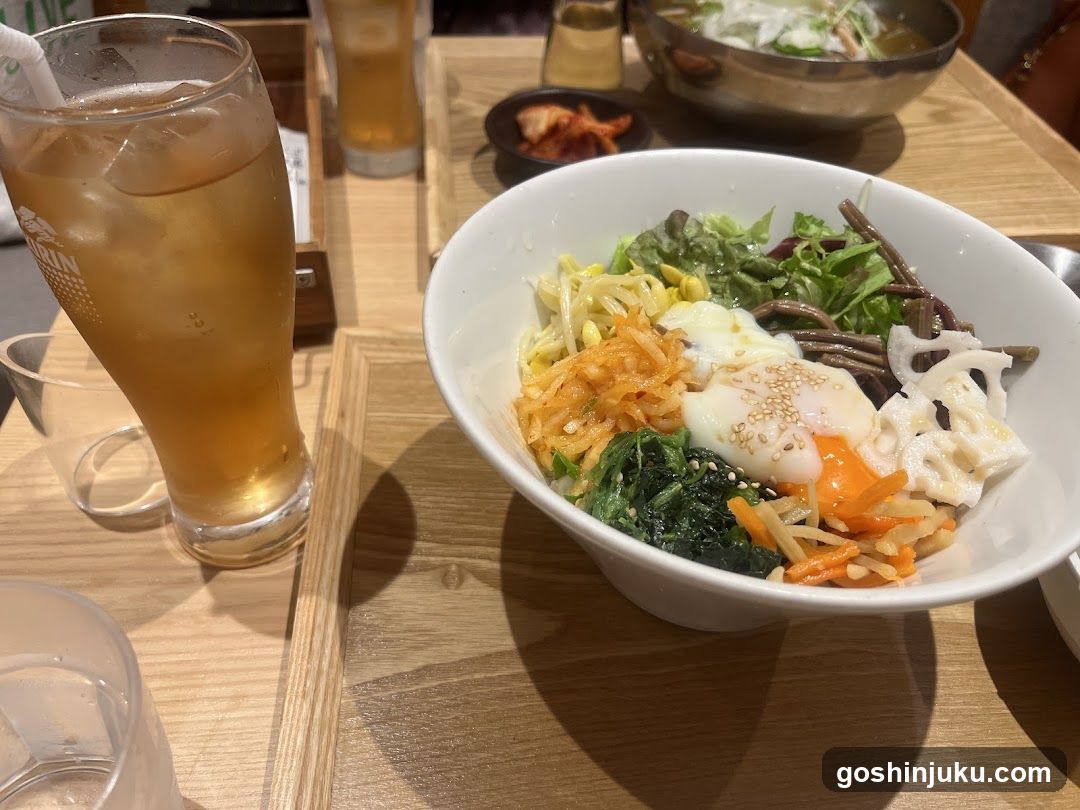 Bowl of Bibimbap with Side Dishes and Drink