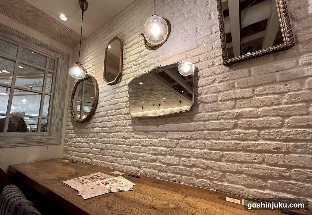 Interior of a restaurant or cafe with white brick wall and mirrors