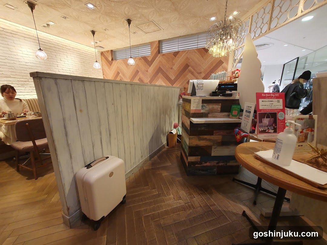 Interior of a cafe or restaurant with wooden decor and a white suitcase near the entrance.
