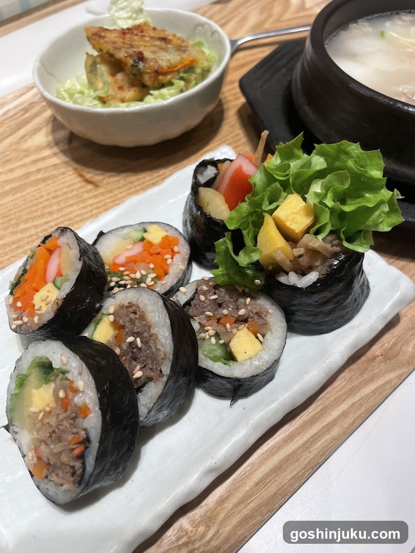 Korean-style food platter with gimbap and side dishes