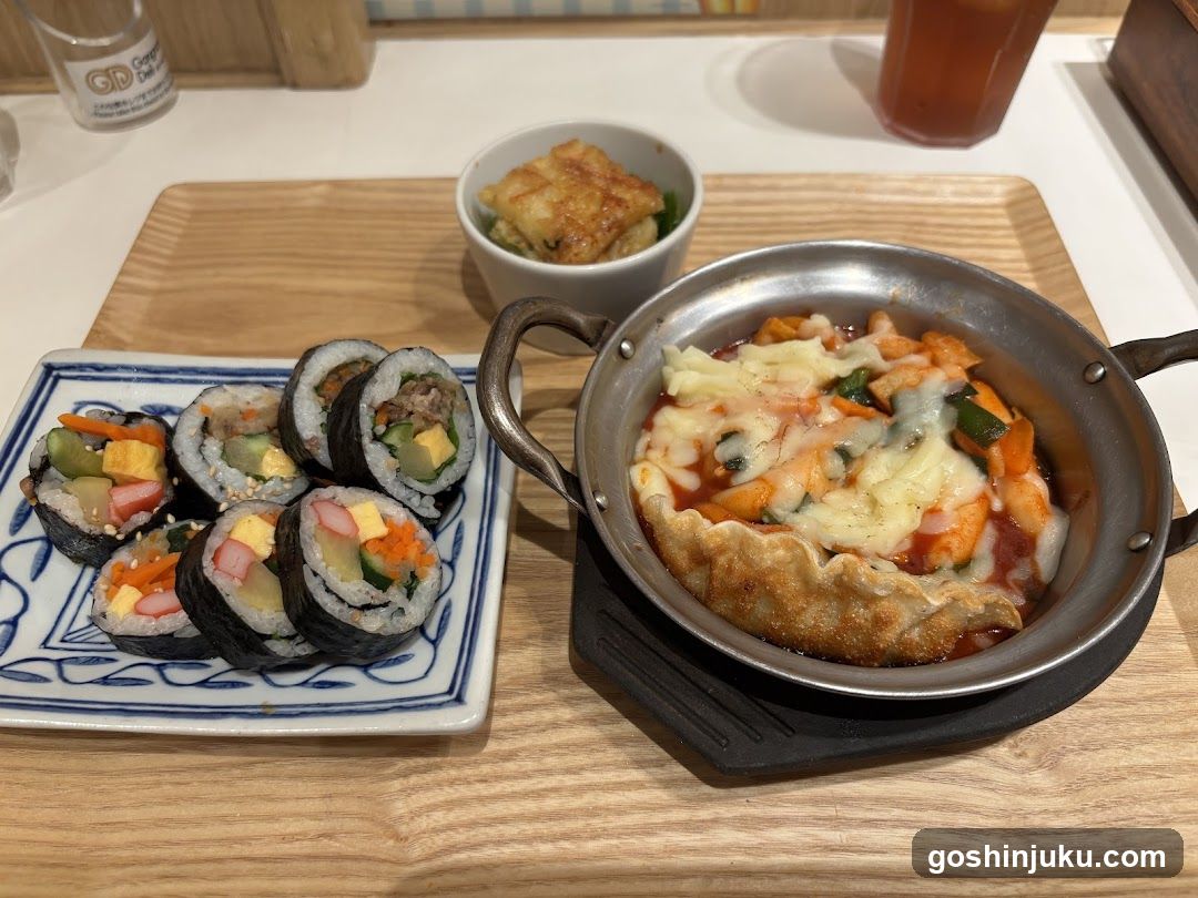 Korean-style meal with rice cakes and spicy shrimp dish
