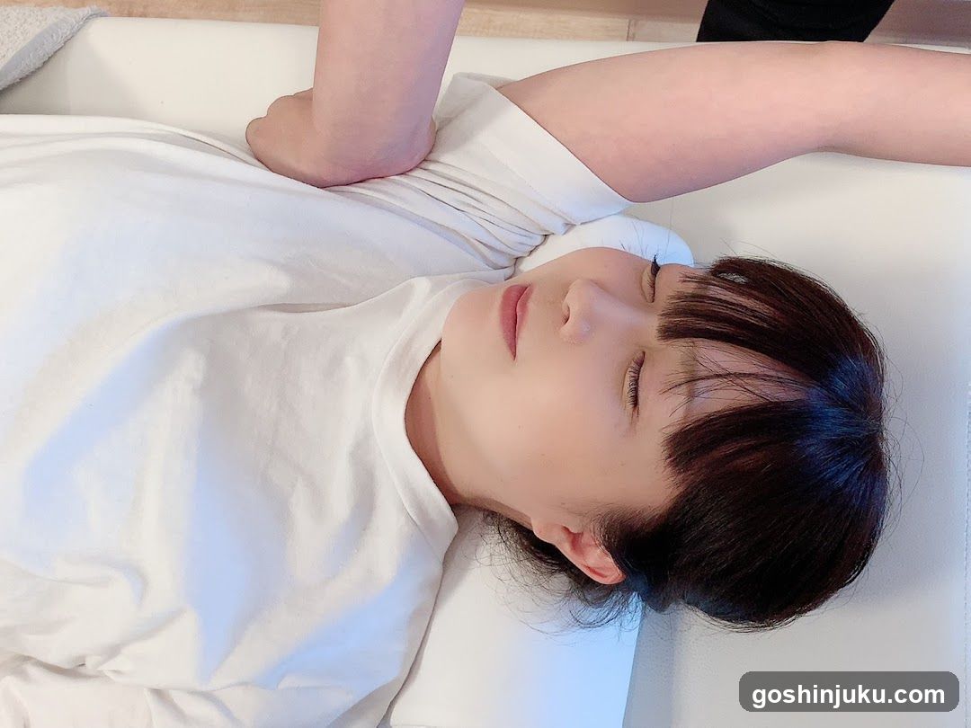 Person lying on a massage table