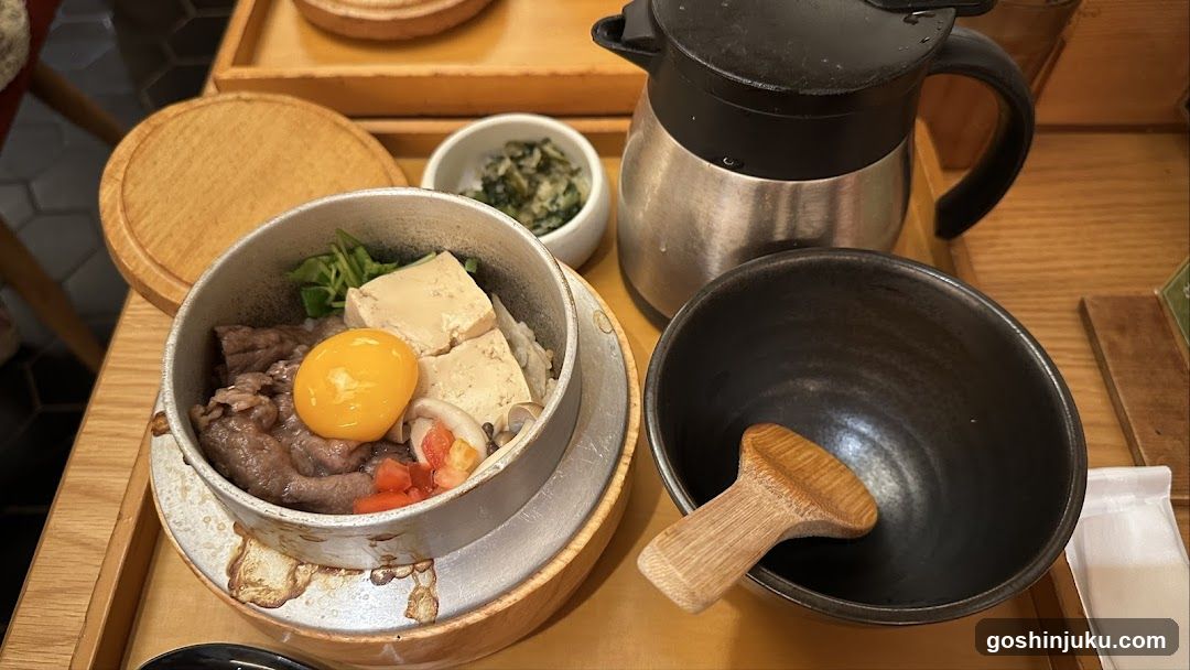 Bowl of food with egg yolk and tofu