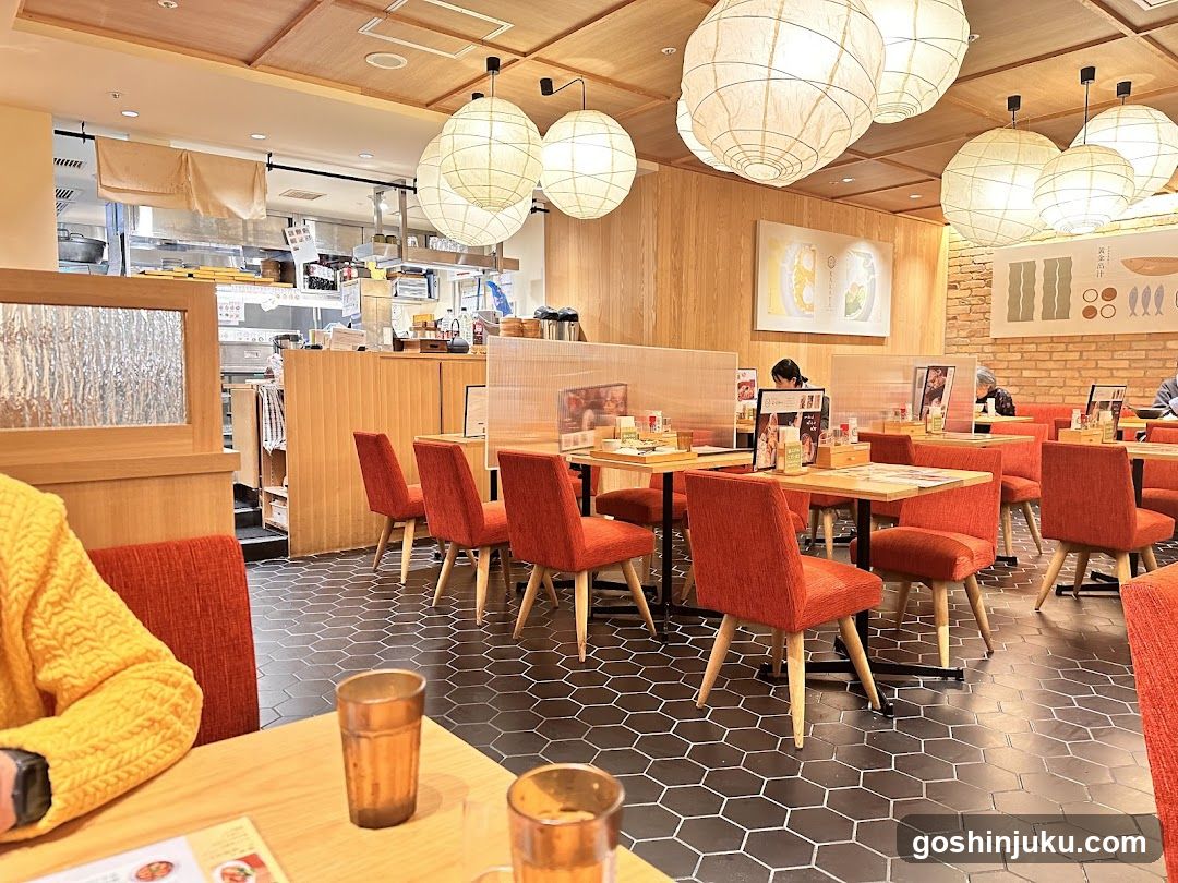 Restaurant Interior with Orange Chairs and Hanging Lamps