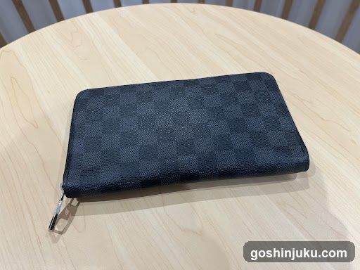 Dark Checkered Wallet on Table