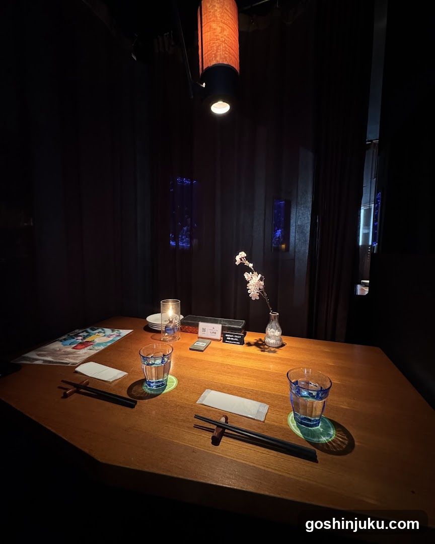 Dimly lit dining table with chopsticks and glasses