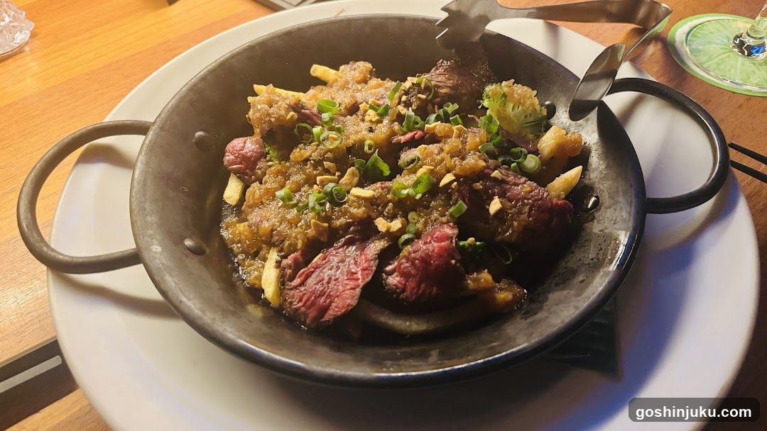 Sizzling Meat Dish in Metal Skillet
